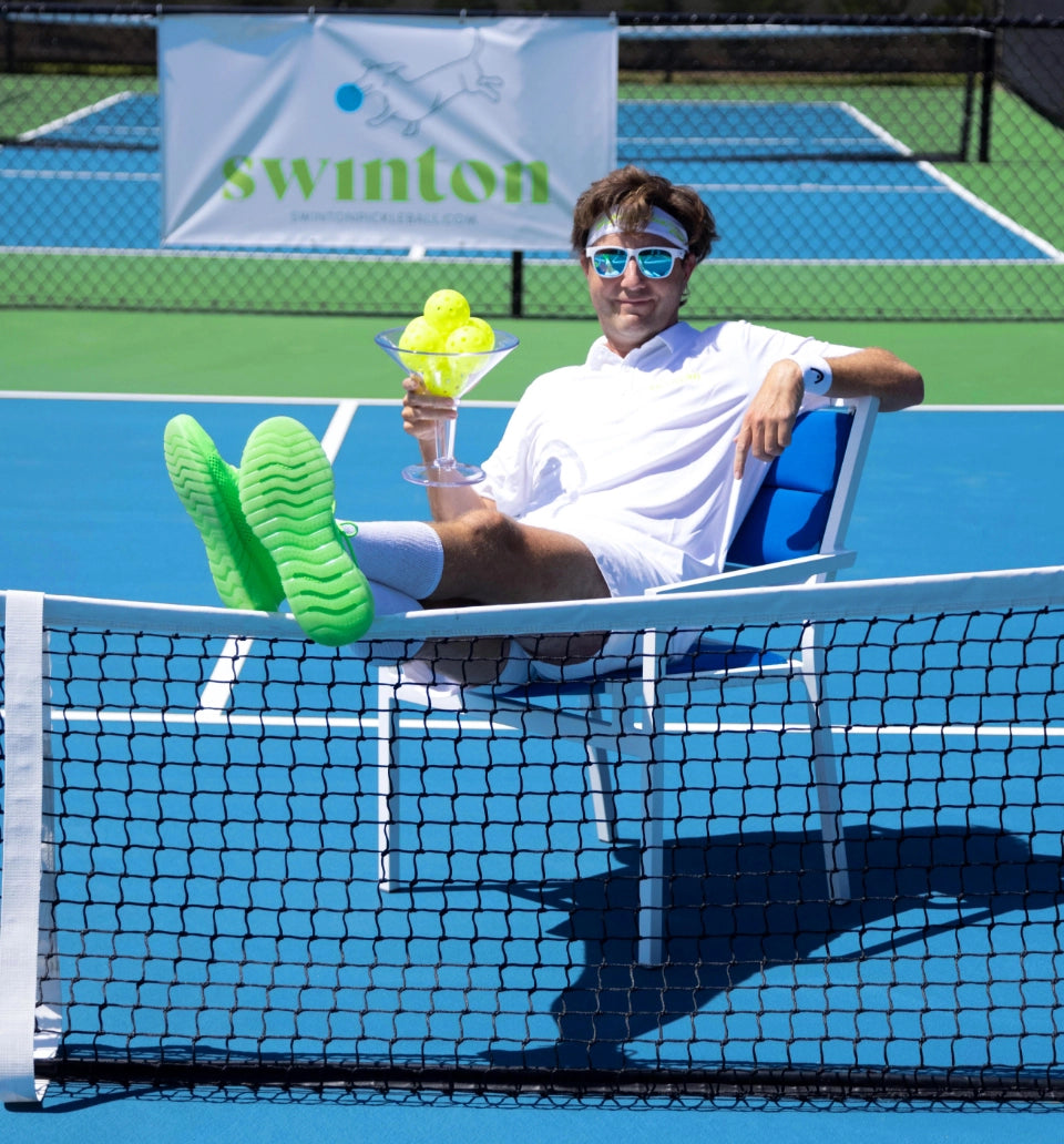 Pickleball player on court with martini.