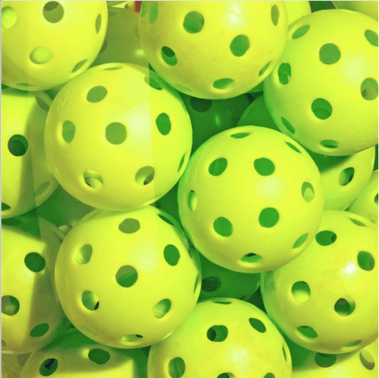 Collection of bright green pickleballs.