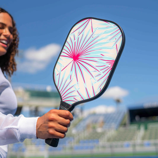 Girl holding flowered pickleball paddle.