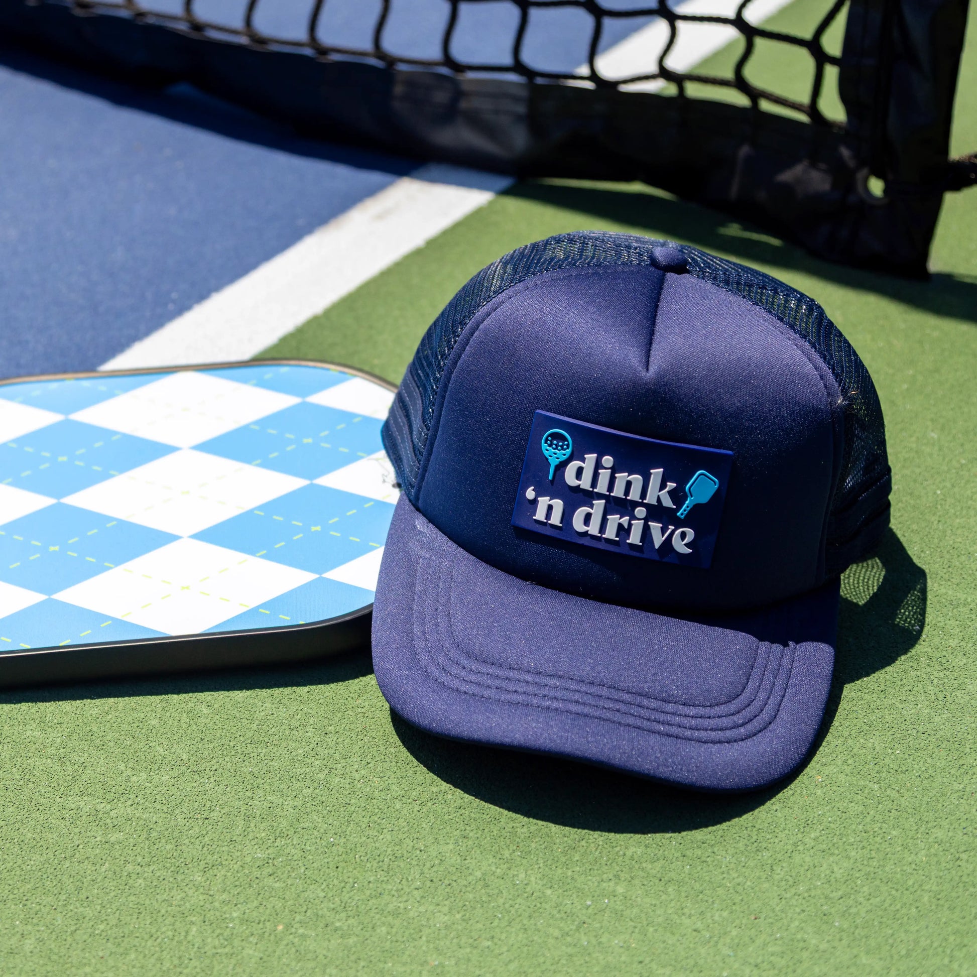 blue hat on pickleball court golf hat and pickleball hat dink and drive