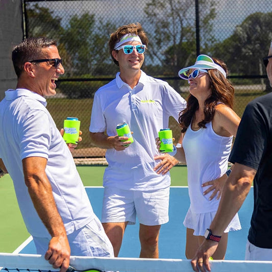 Pickleball players laughing on court.