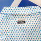 Shirt with blue pattern and 'Kitchen's Closed' label on a blue background