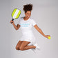 woman jumping for joy wearing swinton pickleball gear in a kitchens closed shirt and paddle
