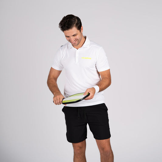 man in white swinton pickleball polo holding a green paddle